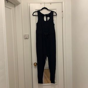 TORRiD Size 00, Black Ribbed Straight Legged Waisted Jumpsuit With Pockets.